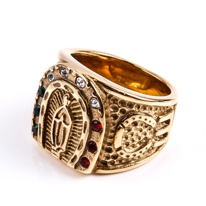 Macro shot of gold Virgin Mary signet ring with green, white and red rhinestones