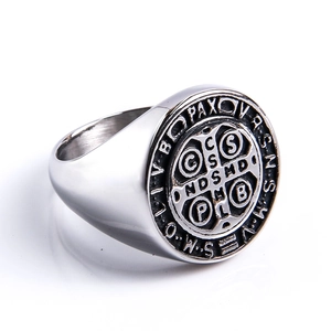 Detail of vintage Saint Benedict Medal ring featuring an engraved cross in silver steel