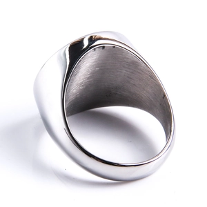 Macro detail of male signet ring showing internal brushed texture and polished steel finish