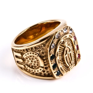 Detailed view of vintage gold signet ring with Virgin Mary icon and colorful rhinestones