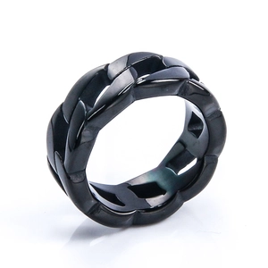 Macro shot of industrial black stainless steel ring with hollow Cuban chain link pattern