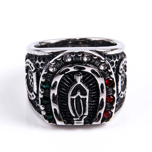 Macro shot of vintage Guadalupe saint relief with colorful rhinestones on a wide ring band