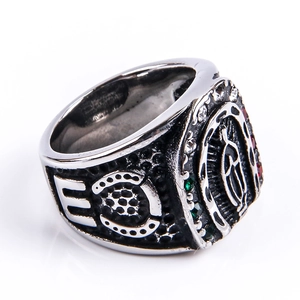 Macro shot of vintage Virgin Mary relief on silver stainless steel ring with red gemstones