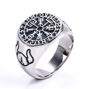 Detailed close-up of Viking compass ring with engraved runes and wolf side relief