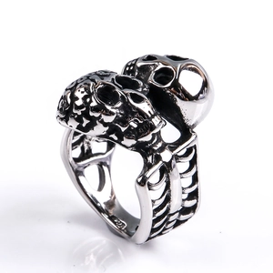 Macro detail of gothic double skull ring with intricate skeletal rib cage textures