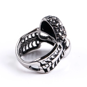 Detailed view of silver punk ring featuring a hollow rib cage structure and rock texture