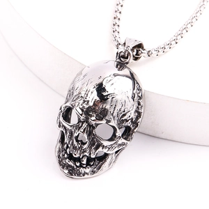 Macro detail of gothic skull pendant with vintage silver finish on box chain