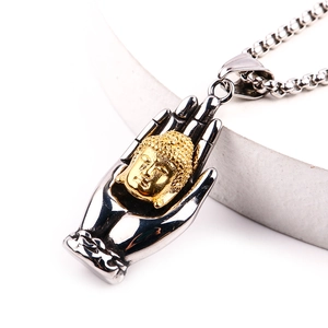 Close-up of retro stainless steel palm pendant with golden Buddha head detail