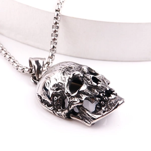 Detailed macro view of vintage silver stainless steel skull pendant with oxidized finish