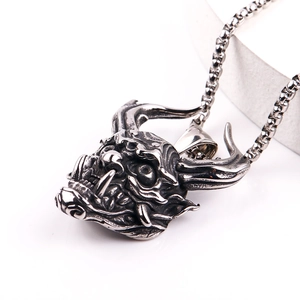 Detailed close-up of retro stainless steel devil skull pendant with vintage oxidized finish