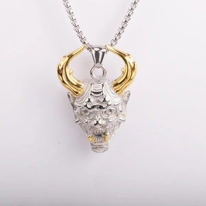 Detailed close-up of a two-tone silver and gold Hannya demon skull pendant on ball chain