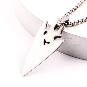 Close-up of vintage stainless steel arrow pendant with brushed metal texture and box chain