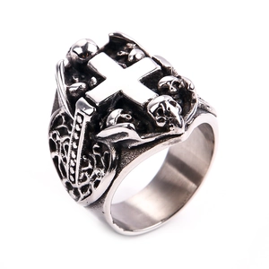 Detail of gothic stainless steel ring with 3D cross and skull relief carvings
