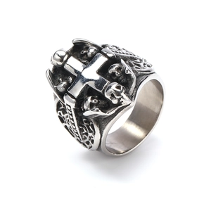 Macro detail of vintage punk cross and skull ring in oxidized stainless steel