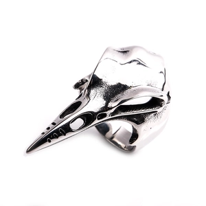 Detailed close-up of a vintage steel bird skull ring with gothic punk textures