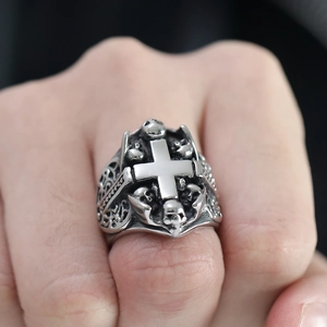 Macro detail of gothic stainless steel cross ring with skull design and vintage silver finish