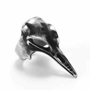 Macro view of vintage silver raven skull ring featuring gothic bone textures and details