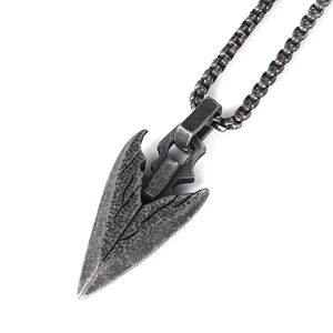 Macro shot of vintage sword arrow pendant in oxidized stainless steel with worn texture