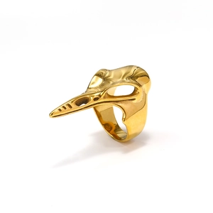 Macro detail of gothic golden bird skull ring with high-polished mirror metal finish