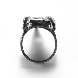 Macro shot of retro stainless steel skull ring with distressed finish and industrial texture
