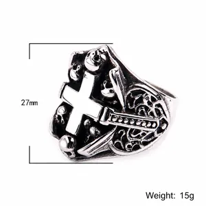 Retro gothic stainless steel ring with cross and skull relief on white background
