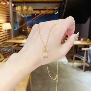 Elegant gold lock and key pendant necklace with sparkling pavé zircon stones