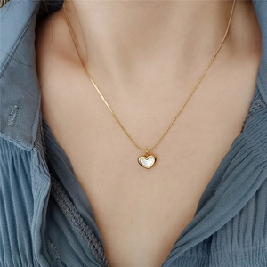 French vintage heart necklace with white mother of pearl in gold plated steel worn on model