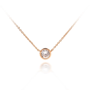 Minimalist 18K rose gold necklace with a bezel-set round diamond pendant on a white background