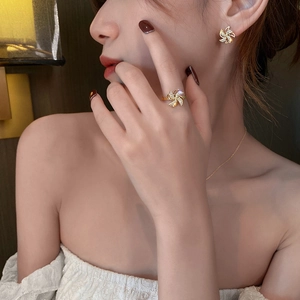 Detail view of a gold-plated rotating windmill jewelry set with shimmering crystals