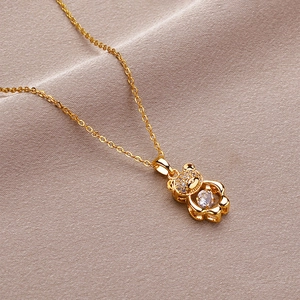 Golden teddy bear necklace with sparkling dancing zircon pendant on fine chain