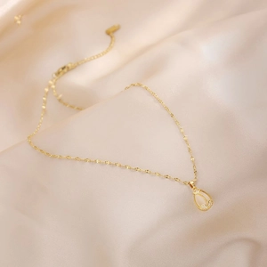 Elegant gold tulip necklace with yellow gemstone and tiny diamonds on silk background