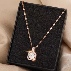Elegant rose gold dancing zircon pendant necklace displayed on champagne satin fabric
