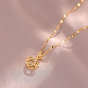 Elegant gold-plated fortune bag pendant necklace with zircon crystals on silk background