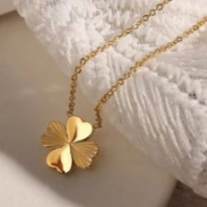 Elegant gold four-leaf clover pendant necklace with polished and textured heart petals