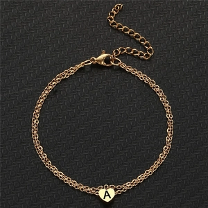 Gold double-chain bracelet with heart-shaped letter A pendant and lobster clasp detail