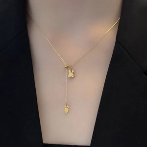 Golden titanium steel Y-shaped necklace featuring cute rabbit and carrot pendants