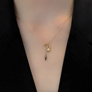 Golden rabbit and carrot titanium steel Y-shaped necklace shown on a model neck
