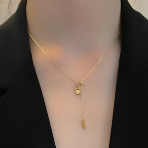 Golden Y-shaped titanium steel rabbit necklace with heart pendant on model