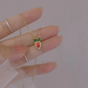 Cute carrot pendant necklace with orange zircon and green gemstones on gold chain