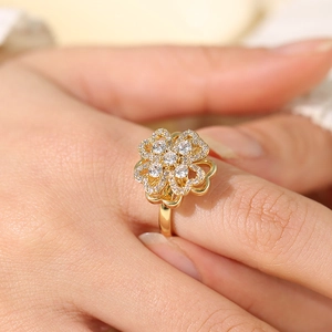 Luxurious gold four-leaf clover ring with sparkling pavé zircons worn on hand