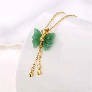 Elegant gold butterfly necklace with green faux jade wings and long tassel charms