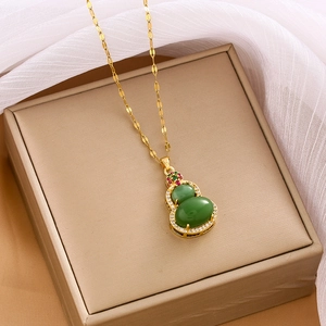 Elegant gold titanium steel necklace with green zircon gourd pendant on a luxury gift box