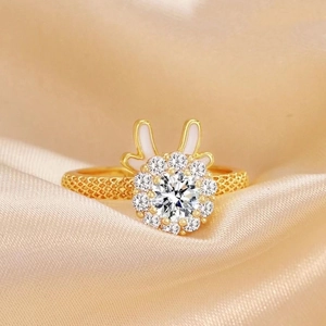 Rotating golden zodiac rabbit ring with large crystal and white enamel ears on silk