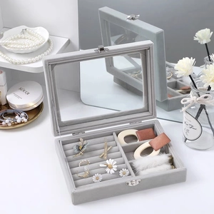 Gray velvet jewelry box with clear glass lid and metal lock for rings and earrings