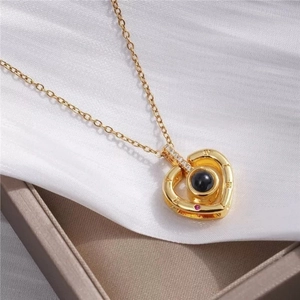 Elegant gold heart pendant necklace with Roman numerals and crystal on white silk