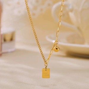Collana in acciaio al titanio placcato oro con ciondolo quadrato Good Luck e perla