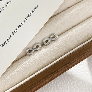 Detailed view of sterling silver infinity stud earrings with sparkling zircon stones