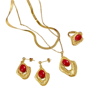 Bohemian gold jewelry set with red stones featuring layered necklaces, earrings, and ring