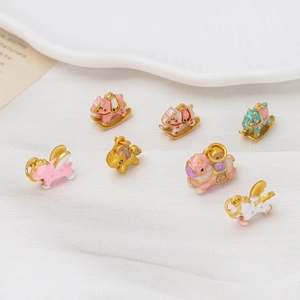 Close-up of assorted enamel rocking horse and unicorn charms for DIY jewelry making