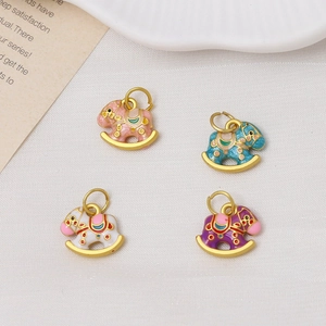 Detail of colorful enamel rocking horse pendants in pink, blue, white and purple colors